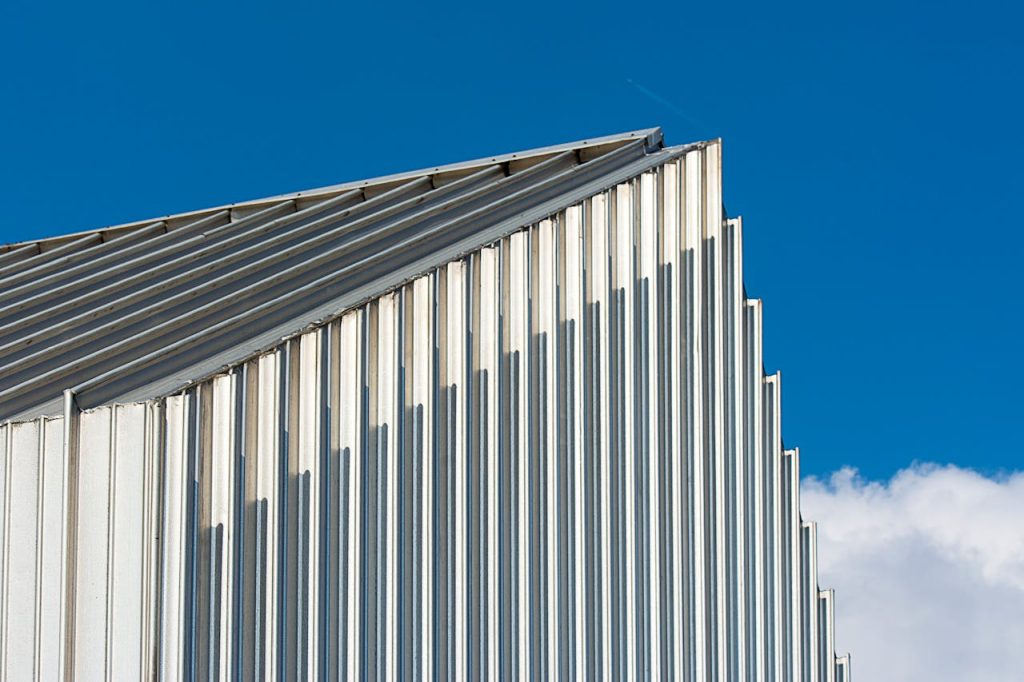  Commercial roofing 
 with Corrugated Metal Building Roof Under Blue Sky